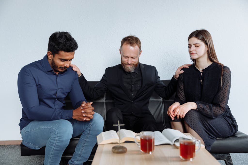 Couple Praying with Priest