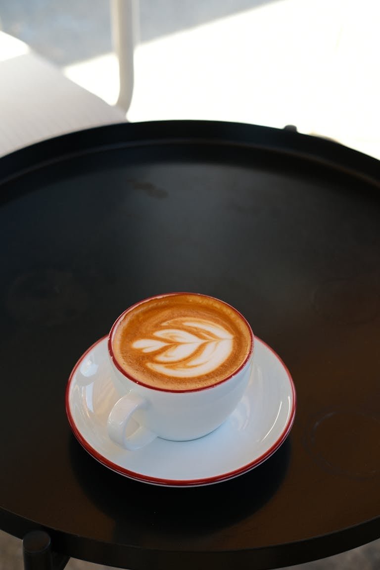 A cup of coffee on a black tray