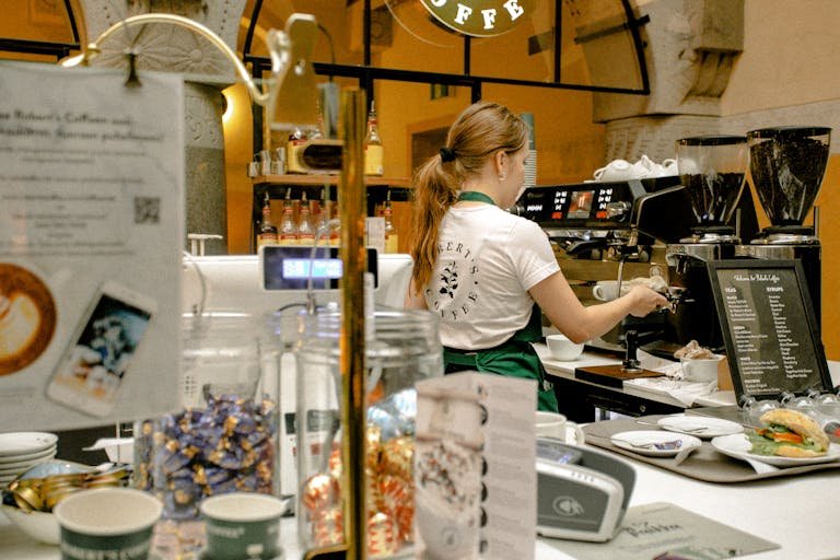 Female Barista Brewing Coffee